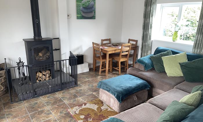 shows the corner sofa, rear window, table and 4 chairs and the Charnwood Cove multi-fuel fire